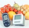 Vintage photo, Glucose meter, blood pressure monitor and fruits with vegetables, healthy lifestyle concept