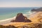 Vintage photo of Lion Rock in the centre of Piha beach. on a beautiful summer day. Auckland, New Zealand.