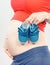 Vintage photo, Pregnant woman with baby shoes, expecting for baby