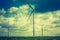 Vintage photo of windmills standing on corn field