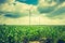 Vintage photo of windmills standing on corn field