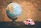 Vintage pink car and globe on a map background