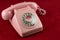 Vintage Pink Telephone on a Mottled Red Table Cloth