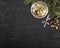 Vintage plate, spoon and fork, nuts, sweets and pine branches on wooden black background