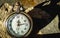 Vintage pocket watch on the cracked concrete floor with the shadow.