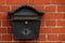 Vintage postbox on brick wall