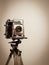 Vintage Press Camera on Wooden Tripod