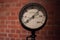 Vintage pressure gauge on blurred brick wall background