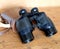 Vintage prism black color binoculars and brown leather case