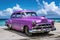 Vintage purple American car in Cuban coast