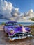 Vintage purple American car in Cuban coast