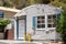 Vintage Quonset hut, tiny home building, corrugated metal weathered old house, alternative affordable housing