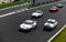 Vintage racing car, classic retro motor sport action, group of cars on asphalt race track