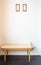 Vintage rattan chair with picture frame on the empty wall background