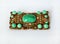 Vintage rectangular brooch with green stones