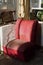 Vintage red armchair covered with dust and cobweb