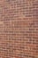 Vintage red brown clay brick wall texture with a rugged and worn look