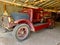 Vintage Red firetruck gathering dust in an old garage