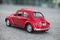 vintage red miniature volkswagen bettle in the street
