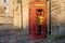 A vintage red telephone box at Palace Green, Durham, UK, converted to house a defibrillator