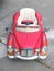 Vintage red toy car for children and kid in the street, toy car parked on road