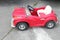 Vintage red toy car for children and kid in the street, toy car parked on road