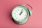 Vintage retro alarm clock on a blank colored minimal background. Time, clock, timing concept.