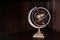 Vintage retro classic zodiac globe armillary sphere model on dark wood background