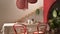 Vintage retro dining room with wooden table and chairs in red tones, breakfast buffet, rattan pendant lamps, parquet floor,