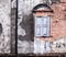 Vintage retro old aged window and brown color textured clay brick block wall. Architectural structural home interior design, house