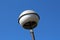 Vintage retro old dilapidated white round street light lamp mounted on metal pole