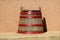 Vintage retro old large wooden wine barrel with red metal hoops converted into decorative flower pot filled with dry plants