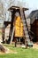 Vintage retro old partially rusted inclined belt conveyor system on small wheels used to transport corn for storing in corn shed