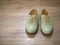 Vintage retro a pair of women green leather shoes on a wooden floor