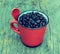 Vintage roasted coffee beans in red cup on the old background