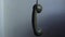 Vintage rotary phone receiver hanging