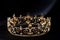 Vintage royal crown, jewellery with emeralds on black background