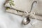 Vintage russian silverspoon with silk ribbon on linen napkin. Old fashion heroloom