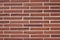 Vintage rustic red color brick wall with a 1/3 offset brickwork pattern