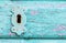 Vintage, rustic turquoise paint wooden door with lock and keyhole