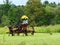 Vintage rusty agriculture crop equipment in empty field