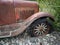 Vintage rusty car with the wooden rims