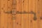 Vintage rusty deadbolt on the old wooden door. horizontal