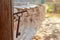 A vintage rusty key hangs on a nail on the wall of an old house, at dawn