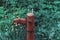 Vintage rusty water fountain hand pump in russian village. Abandoned water wellhead