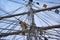 Vintage sailing ship mast ropes and tackle, Tall ship rigging mast detail, blue sky