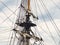 Vintage sailing ship mast ropes and tackle, Tall ship rigging mast detail, blue sky