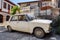 Vintage scrap Fiat 124 car parked in front of a shanty house in the ghetto of Hamamonu district, Ankara, Turkey