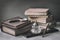 Vintage set with antic books, old stationery, wooden pen, inkwell, magnifier close-up on desk, . Concept of reading and