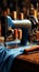 Vintage sewing machine stitches durable blue jeans fabric with precision